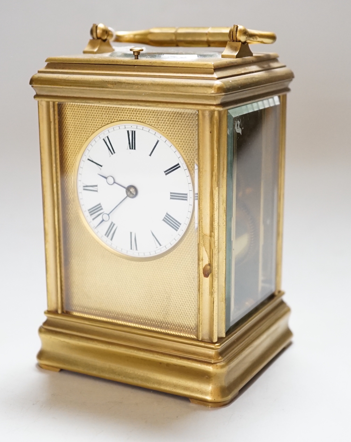 A late 19th century French ormolu, hour repeating carriage clock, with gorge case and enamelled Roman dial, 9.5cm wide, 8.5cm deep, 15cm high